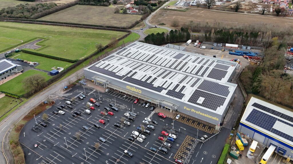 arial drone footage of hawling building services commercial solar pv installation on roof of retail wholesaler